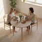 Round drop-leaf dining table with light oak tabletop and wooden legs for small dining space