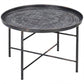 Round coffee table top with hammered design and dark metal X-frame legs