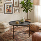 Round coffee table with hammered metal tray top and dark cross-braced metal base