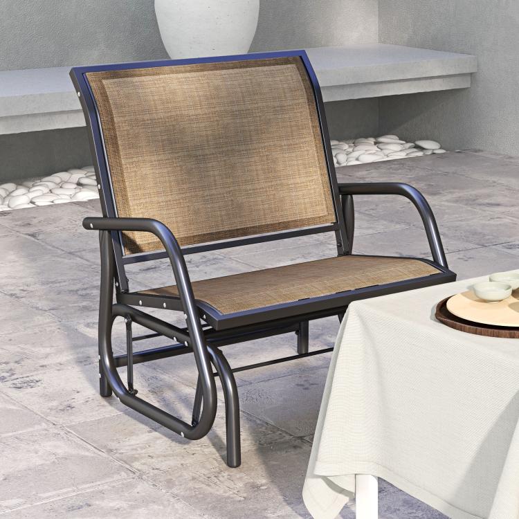 Outdoor glider chair with brown woven seat and backrest, dark frame and armrests