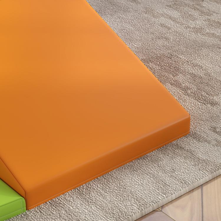 Close-up of orange foam play set slide surface with textured fabric cover