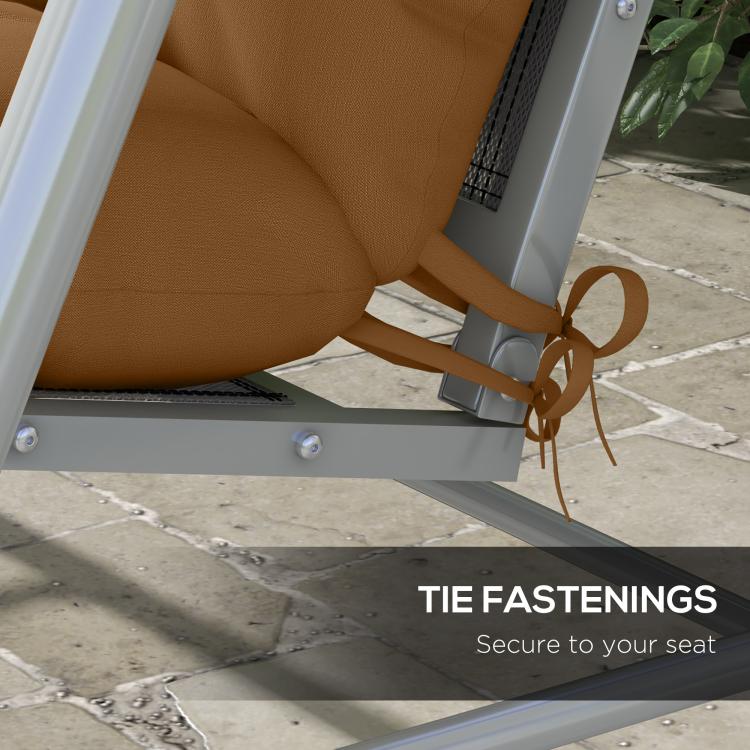 Tan cushion secured to swing seat with tie straps and buckles