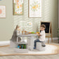 White kids table with two gray-seated chairs and open storage cubbies