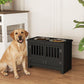 Black dog feeding station cabinet with two stainless bowls and slatted front, with a resting dog