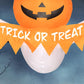 Close-up inflatable Halloween ghost: orange pumpkin face and large “Trick or Treat” banner