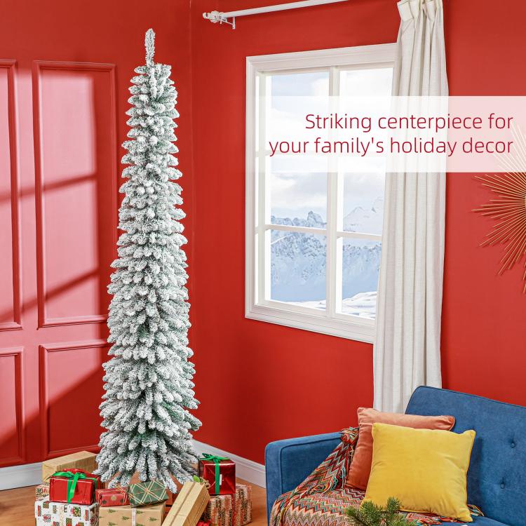 Snow-frosted slim artificial Christmas tree, upright on metal stand