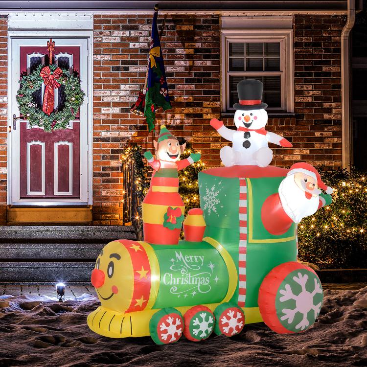 Inflatable Christmas train featuring Santa snowman and elf, with front yellow bear-like face car