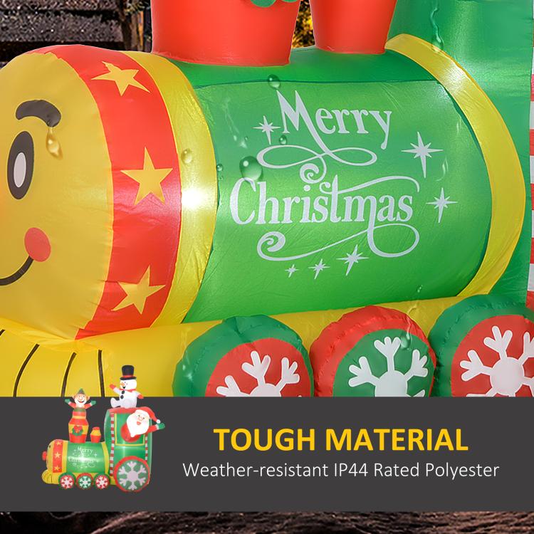 Green inflatable train car with “Merry Christmas” graphic and red wheel covers