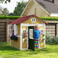 Outdoor wooden playhouse with green door, side windows, and red roof