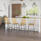 Set of rattan counter bar stools with woven backrests and black steel legs in a kitchen