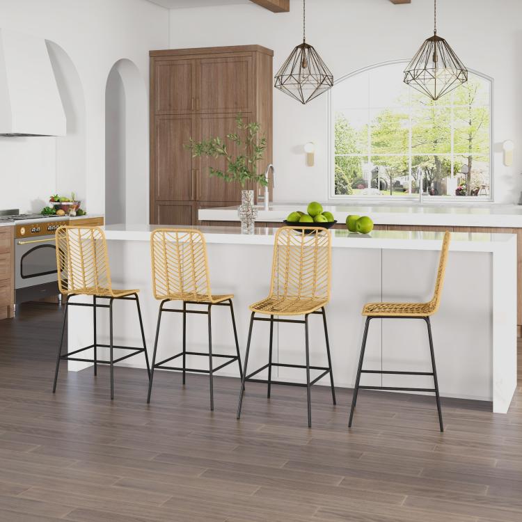 Set of rattan counter bar stools with woven backrests and black steel legs in a kitchen