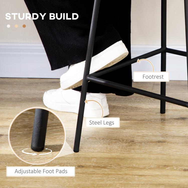 Rattan bar stool showing black steel legs with footrest and adjustable foot pads