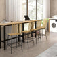 Set of rattan dining bar stools with woven seats and black steel legs around a table