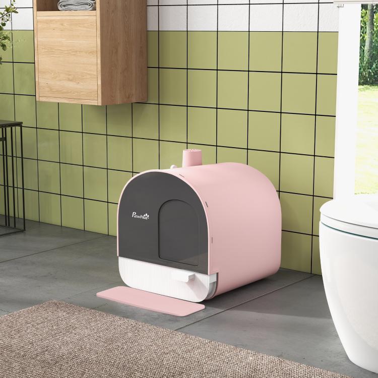 Pink covered cat litter box with dark door and pink mat in front