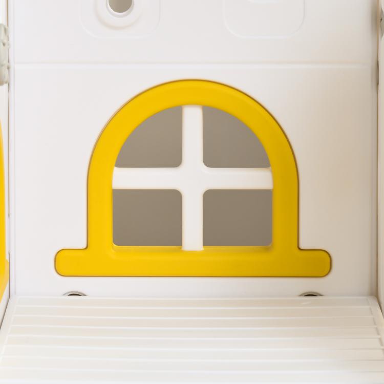 Close-up of yellow arched window panel on white toddler slide and swing playset