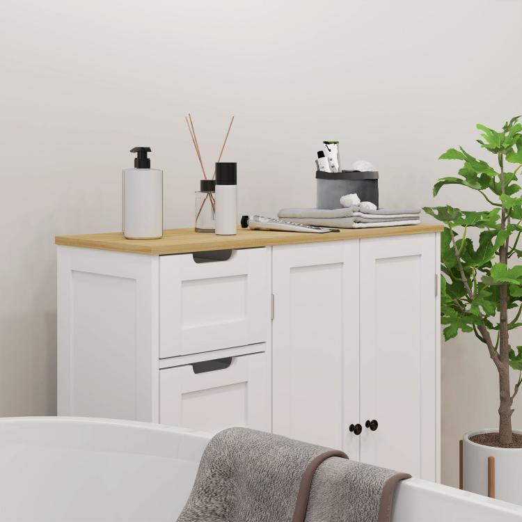 Freestanding bathroom floor cabinet with white doors and drawers, oak top and round knobs.