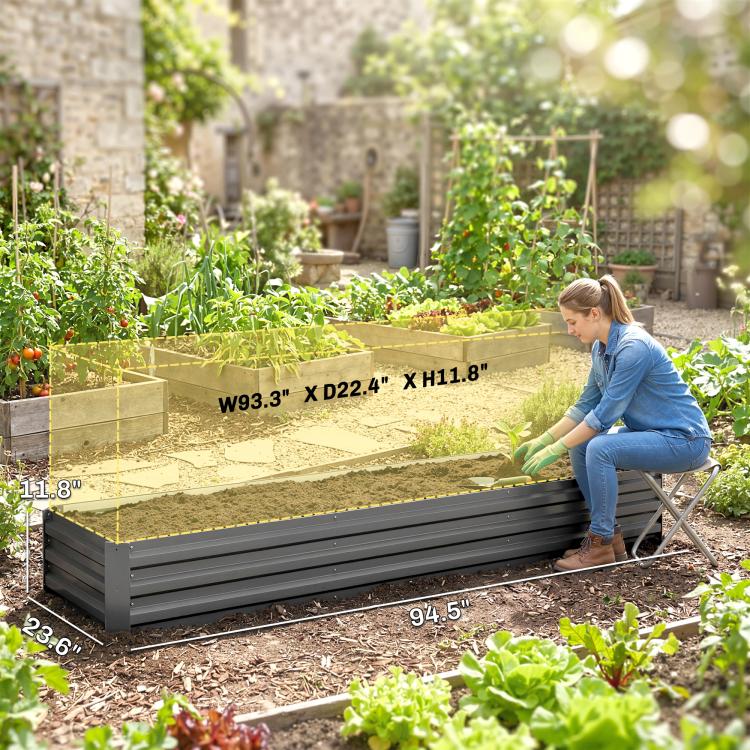 Dark gray raised galvanized garden bed with planting area and surrounding garden plants