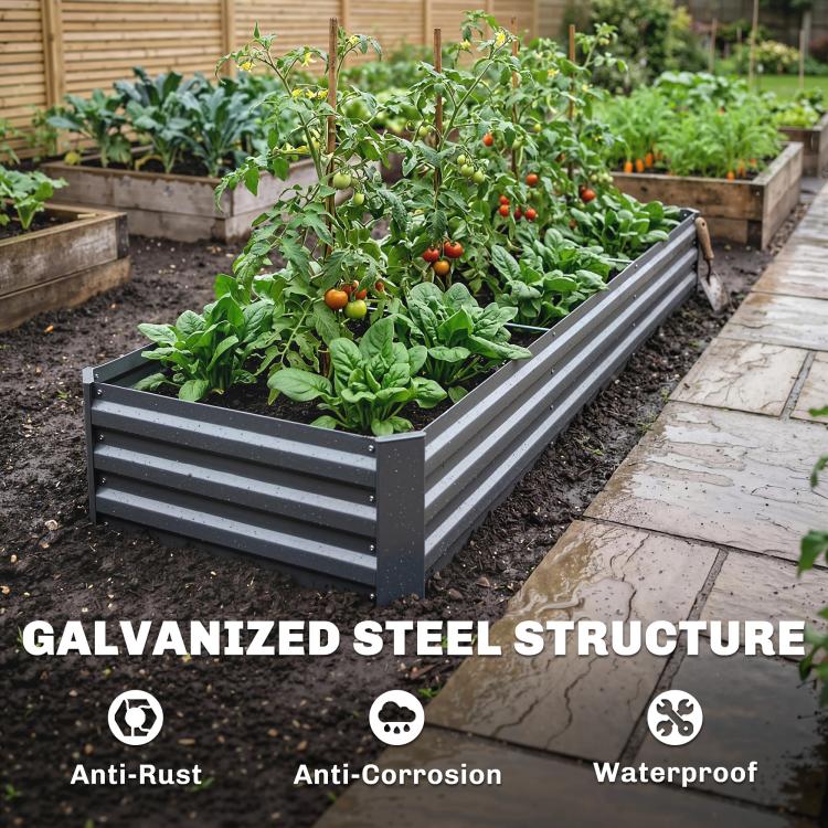 Dark gray raised galvanized garden bed with leafy greens and fruiting plants