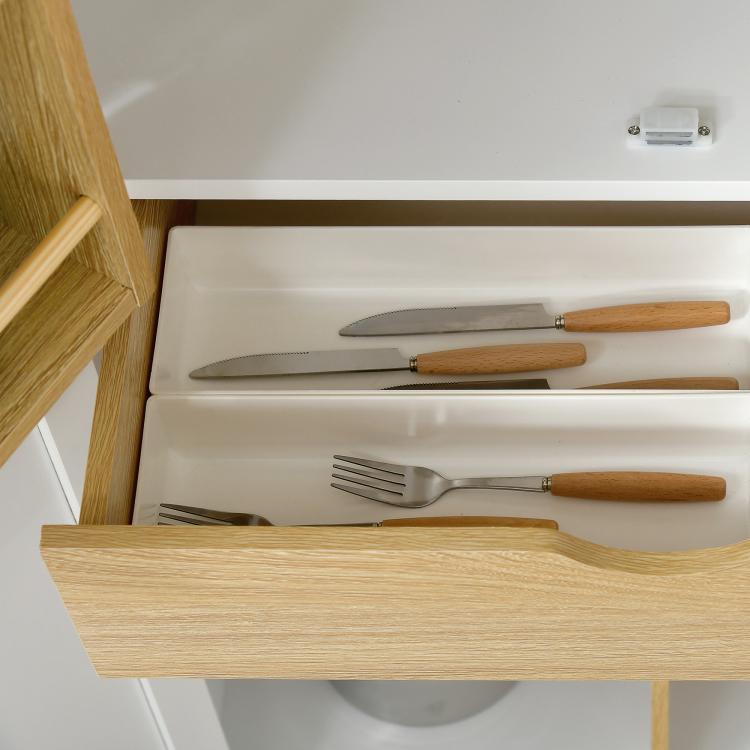 Kitchen pantry storage cabinet drawer open with wooden handle; cutlery stored inside