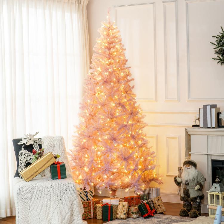 Pink pre-lit artificial Christmas tree, full silhouette with warm white LED lights