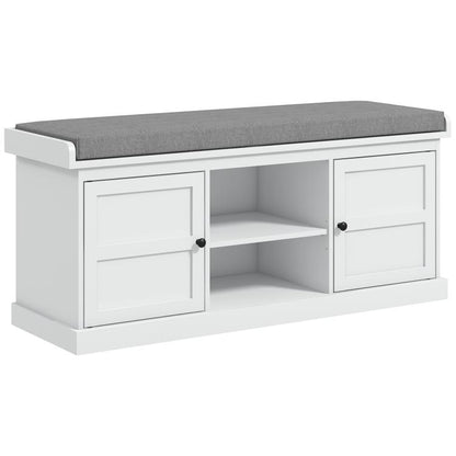 White shoe storage bench with gray cushioned top and two open cabinet doors