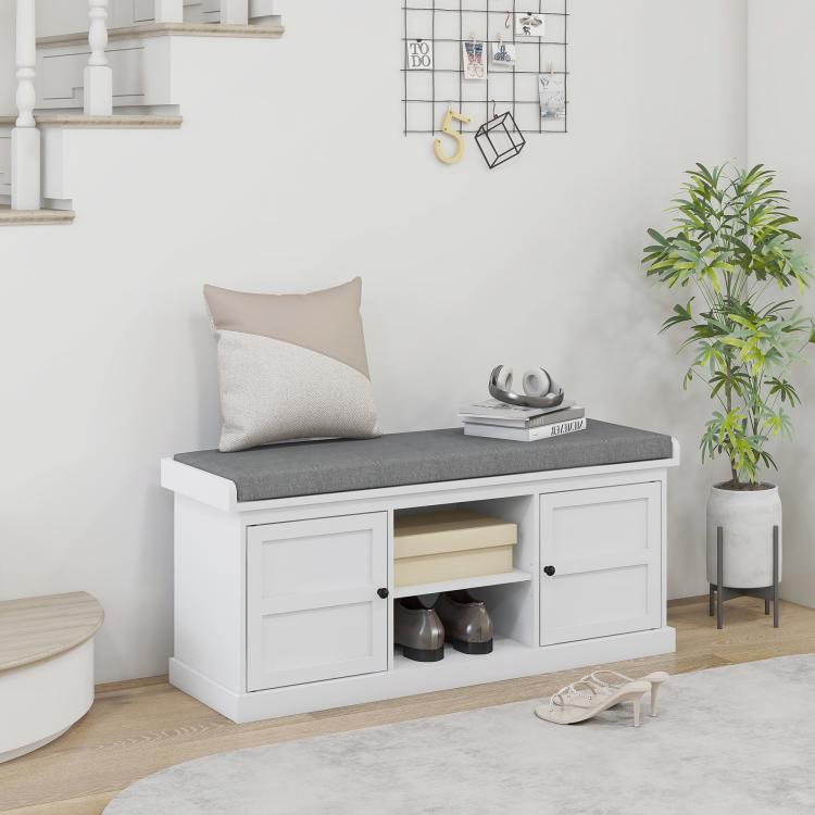 White shoe storage bench with gray cushioned seat and enclosed cabinet compartments