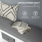 Gray upholstered seat on white shoe storage bench with patterned pillows and removable cover