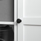 Close-up of black knob handle on white cabinet door of shoe storage bench
