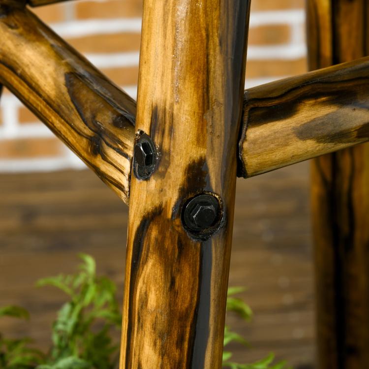 Stained wood windmill weather vane support with black metal rivets, close-up