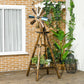 Windmill weather vane on stained wood frame with blue metal blades