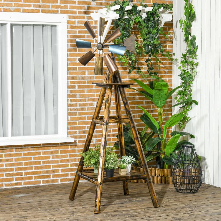 Windmill weather vane on stained wood frame with blue metal blades