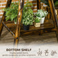 Windmill weather vane bottom shelf holding potted plants and garden ornaments