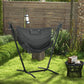 Dark gray hammock chair with headrest pillow and rope fringe on freestanding stand