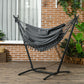 Dark gray hammock chair with headrest pillow, rope net and fringe, on stand