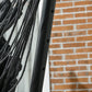 Black powder-coated stand post with hole openings for hammock frame