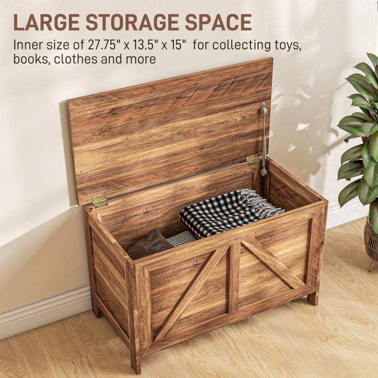 Lift-top storage chest with lid open, interior with folded fabric and plaid cushion, brown wood