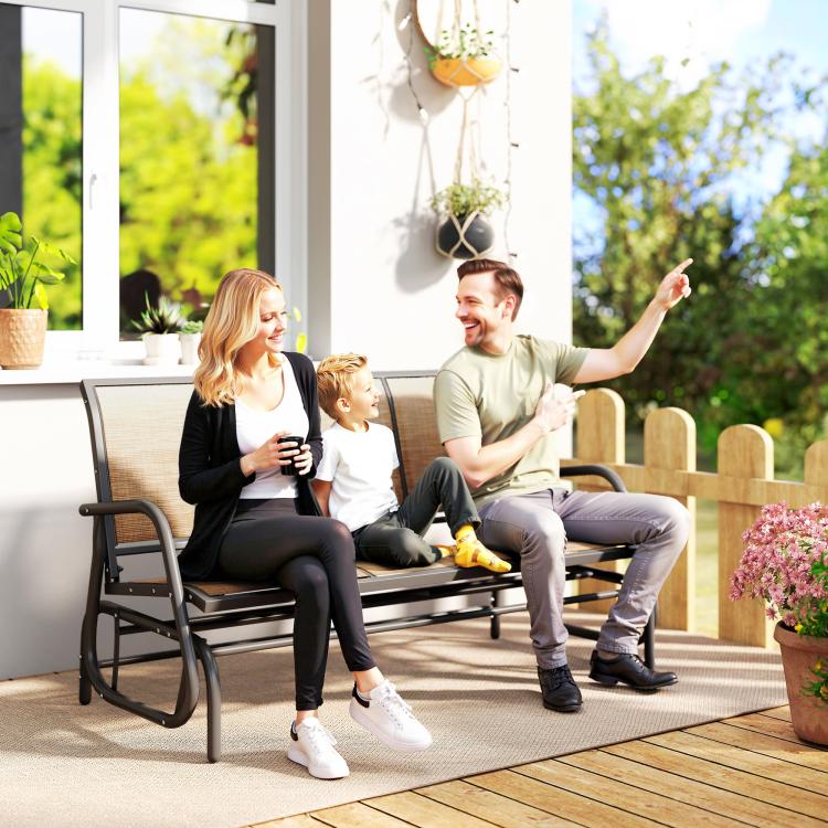 Three-seat patio glider bench with mesh seats and dark metal frame in outdoor setting