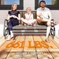 Three-person patio glider bench with brown mesh seat and dark metal base