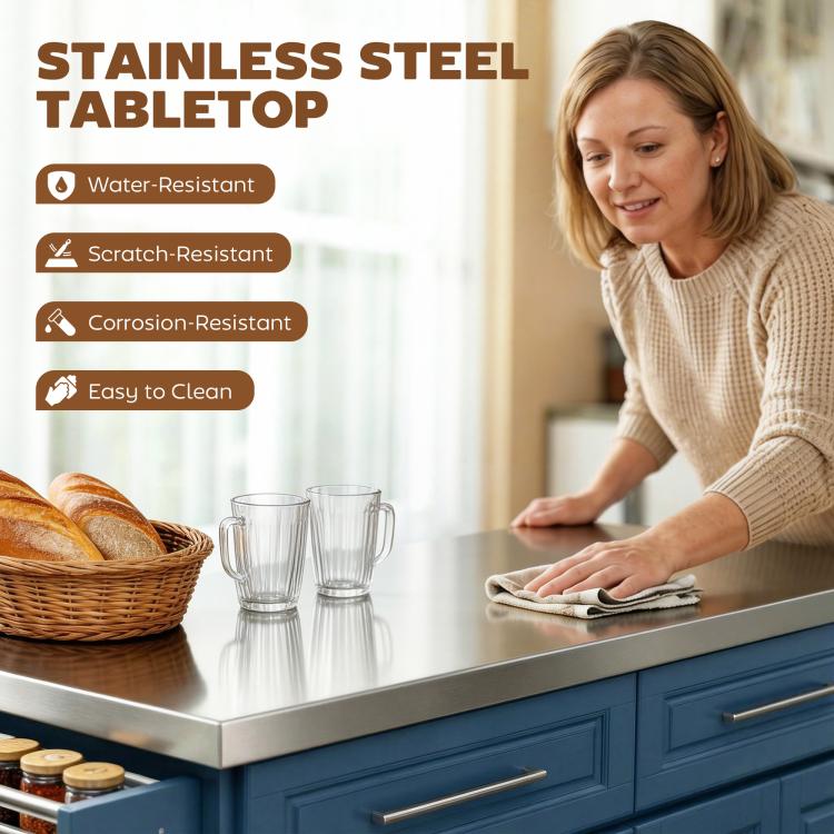 Woman wiping stainless steel tabletop on navy rolling kitchen island; storage cabinets below