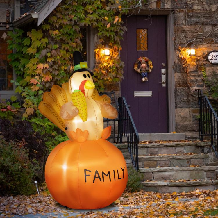 Outdoor lit orange inflatable turkey with pilgrim hat and “FAMILY” on the front.
