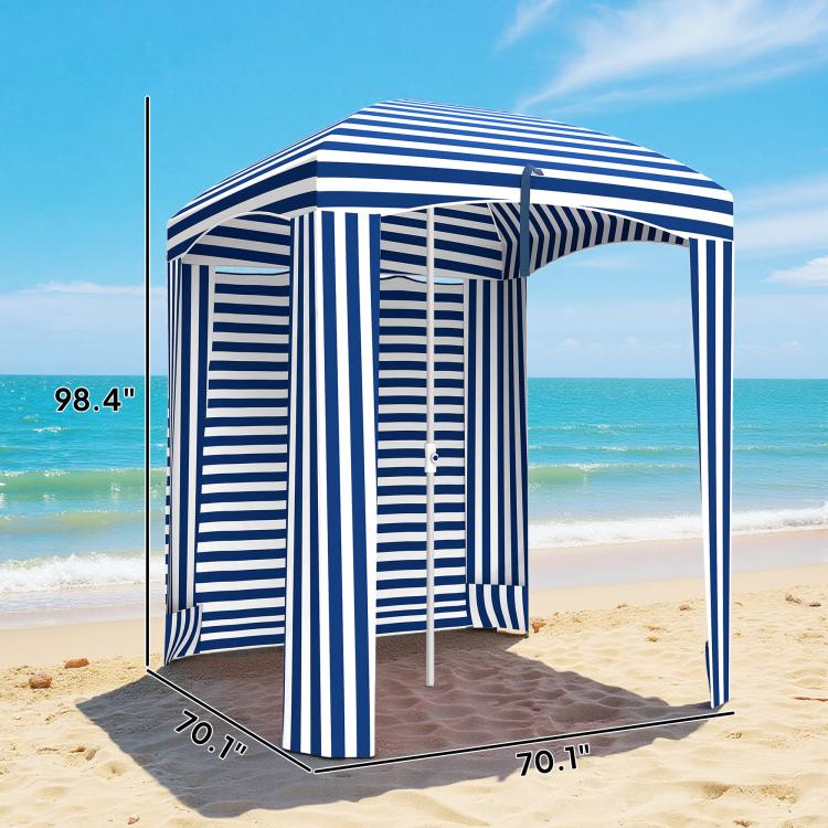 Blue-and-white striped cabana umbrella with walls and open entrance on sandy beach