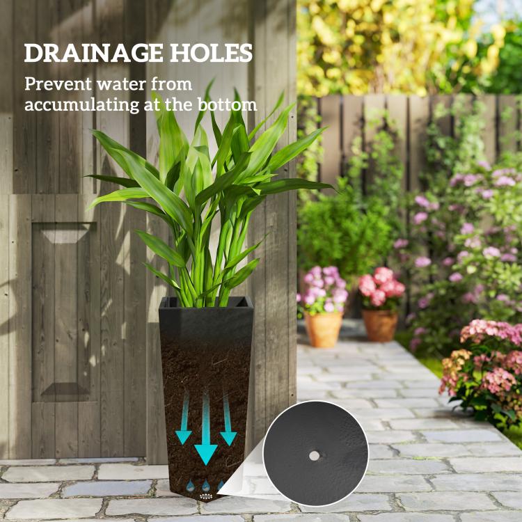 Tall black planter with green plant and a visible drainage hole detail at the base