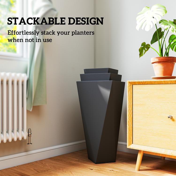 Stackable tall black planter set near indoor radiator, holding a small potted plant