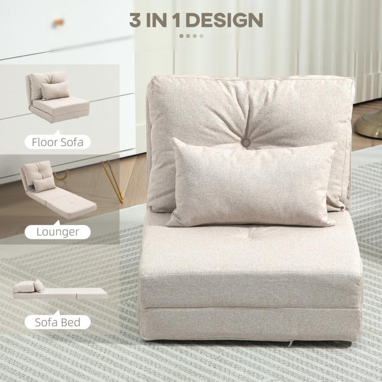 Beige floor sofa bed with tufted back cushion and two pillows