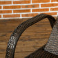 Reclining chaise lounge chair with dark woven wicker frame and curved armrest