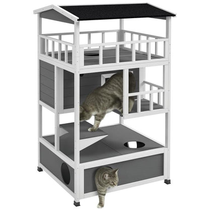 Light gray wooden cat house with asphalt-style roof, escape door, and stacked platforms