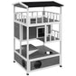 Light gray wooden multi-level cat house with dark asphalt roof and circular openings