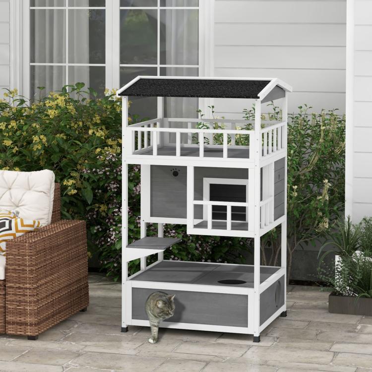 Outdoor light gray wooden cat condo with dark roof, ramp step, and open balcony