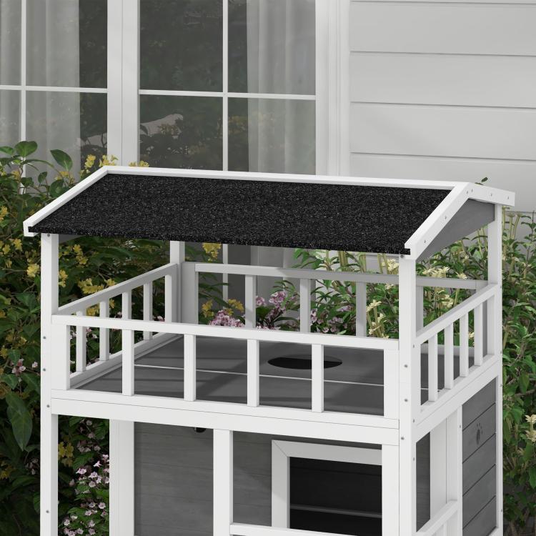 Light gray wooden cat house with black asphalt roof and enclosed balcony with circular holes