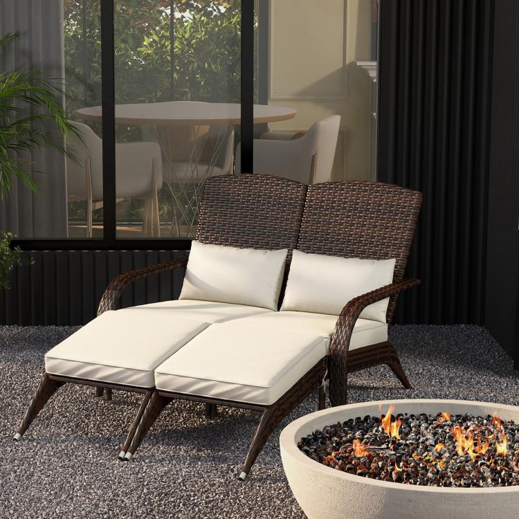 Two-seat wicker adirondack chair with cream cushions and curved armrests